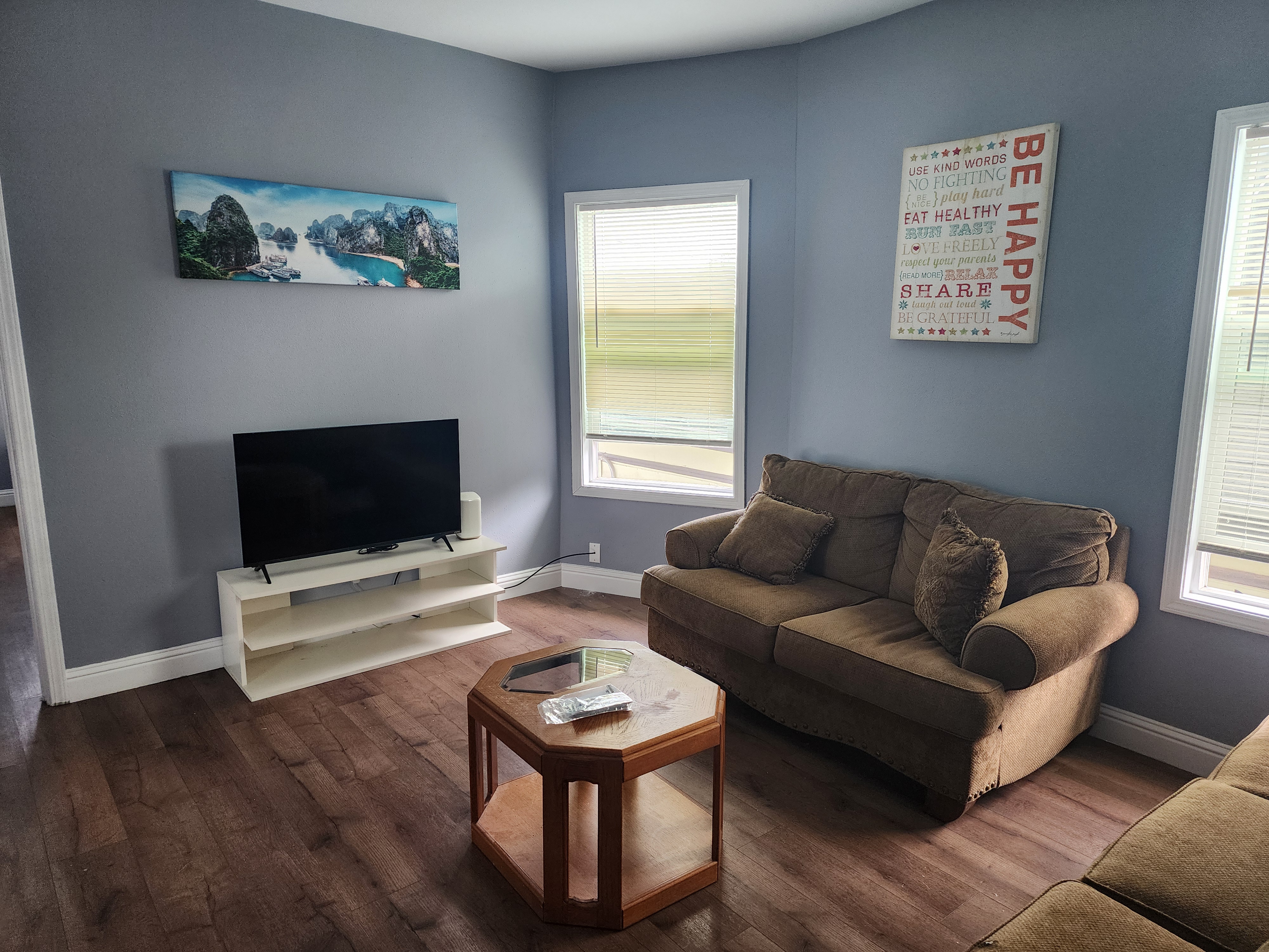 Second view of the shared lounge with seating and television