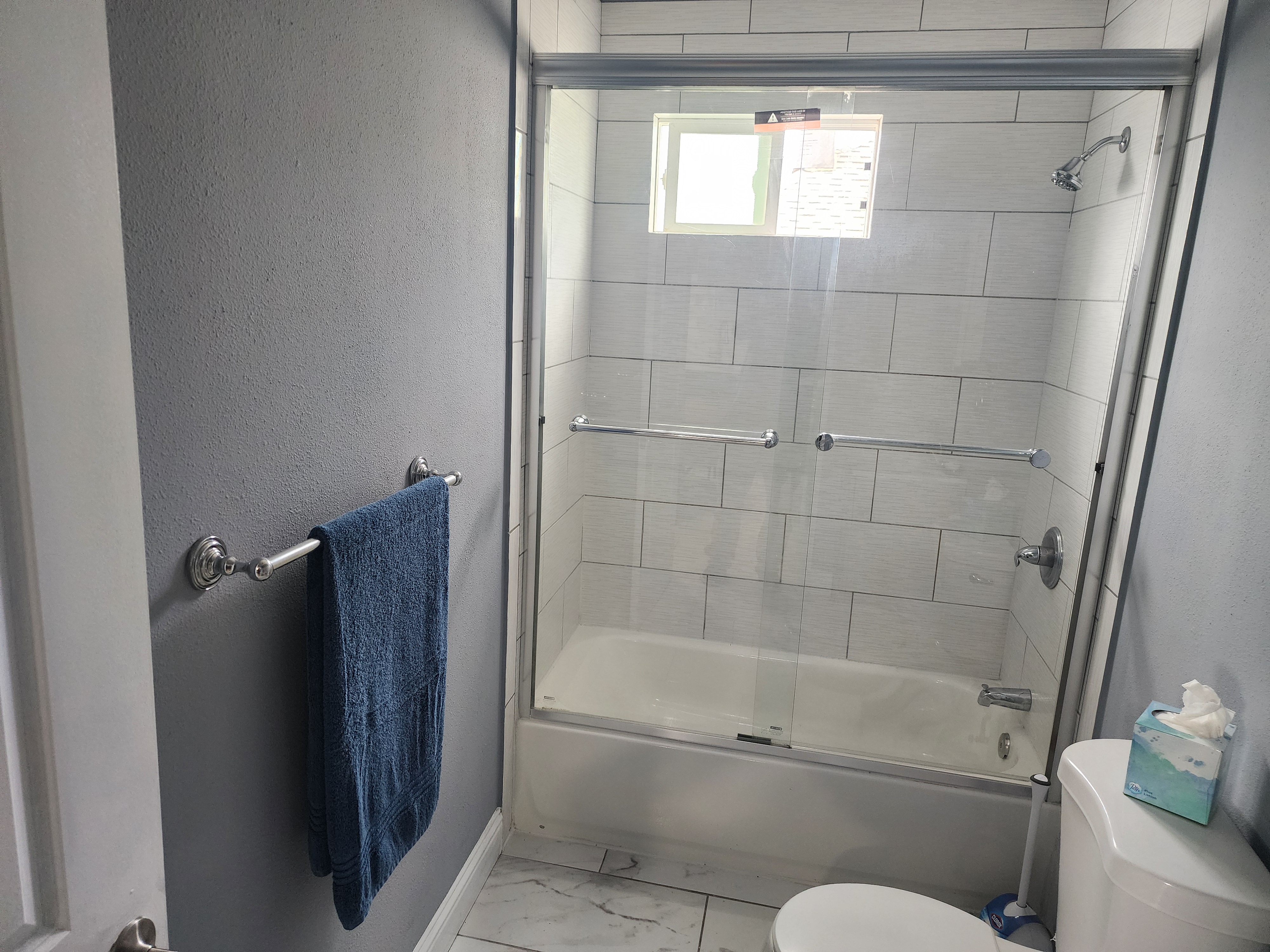 Tiled walk-in shower with safety grab bars